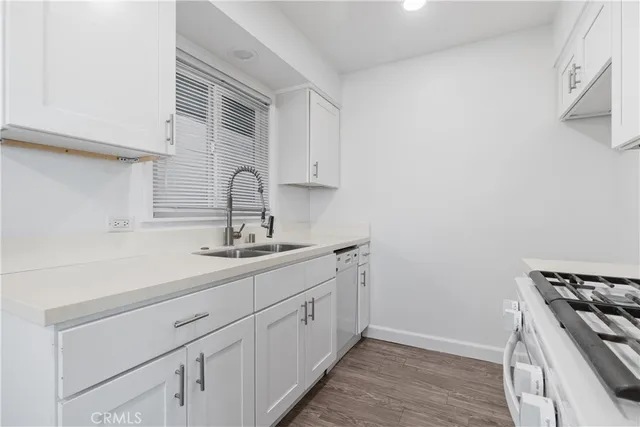 a kitchen with a sink cabinets and stainless steel appliances