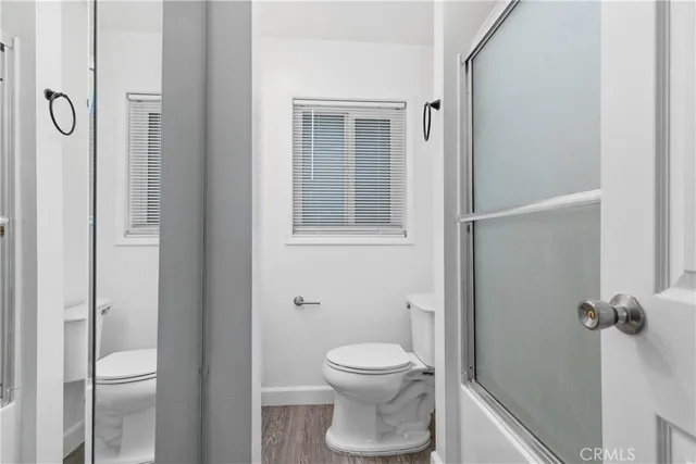a bathroom with a toilet and a shower
