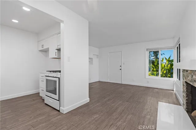 a view of a kitchen with wooden floor and electronic appliances
