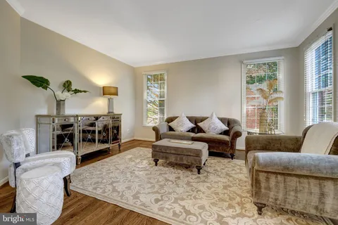 a dining room with furniture a chandelier and wooden floor