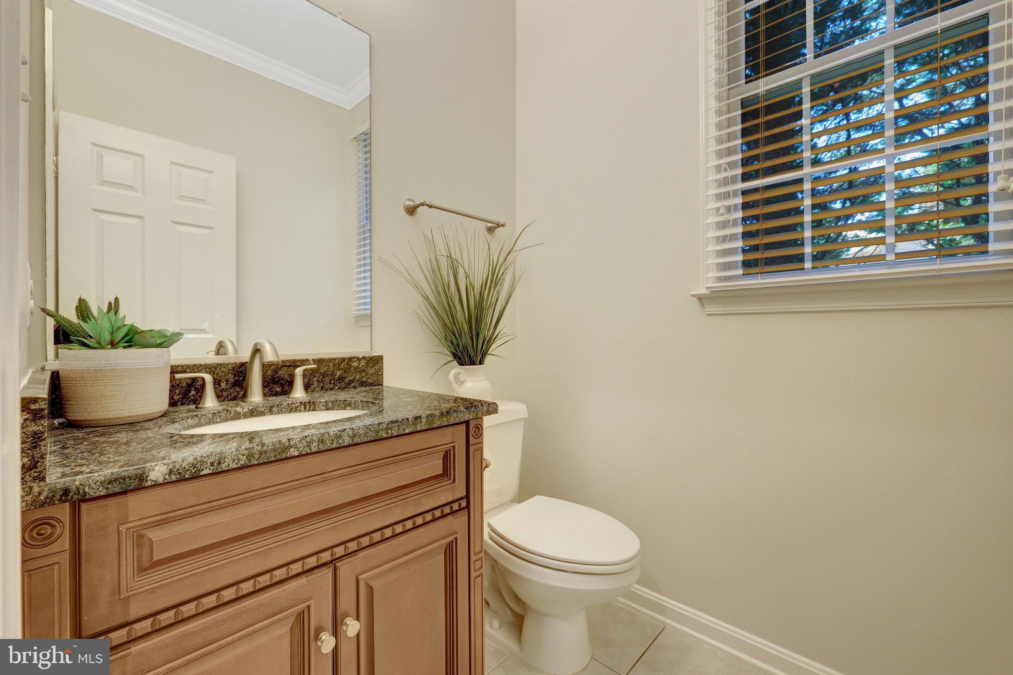 1827 Beulah Road Vienna, VA 22182 - Photo 18 of 91 a bathroom with a granite countertop toilet sink and mirror