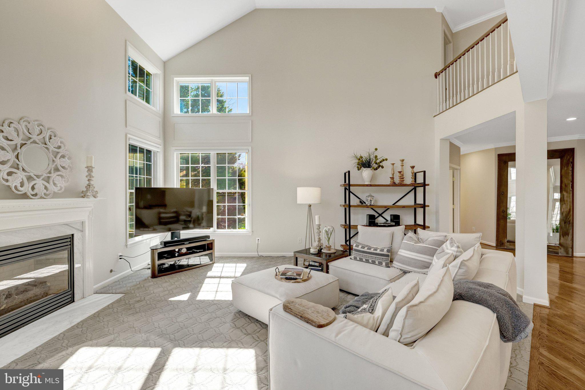 1827 Beulah Road Vienna, VA 22182 - Photo 21 of 91 a living room with furniture a flat screen tv and a fireplace