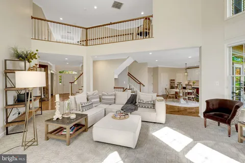 a kitchen with a dining table chairs stove and white cabinets