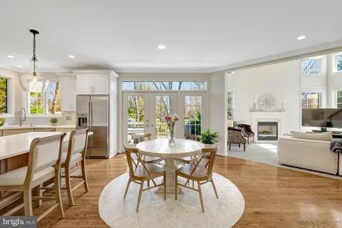 a kitchen with a dining table chairs sink and cabinets