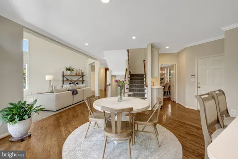 a large kitchen with kitchen island a stove a sink a center island and windows