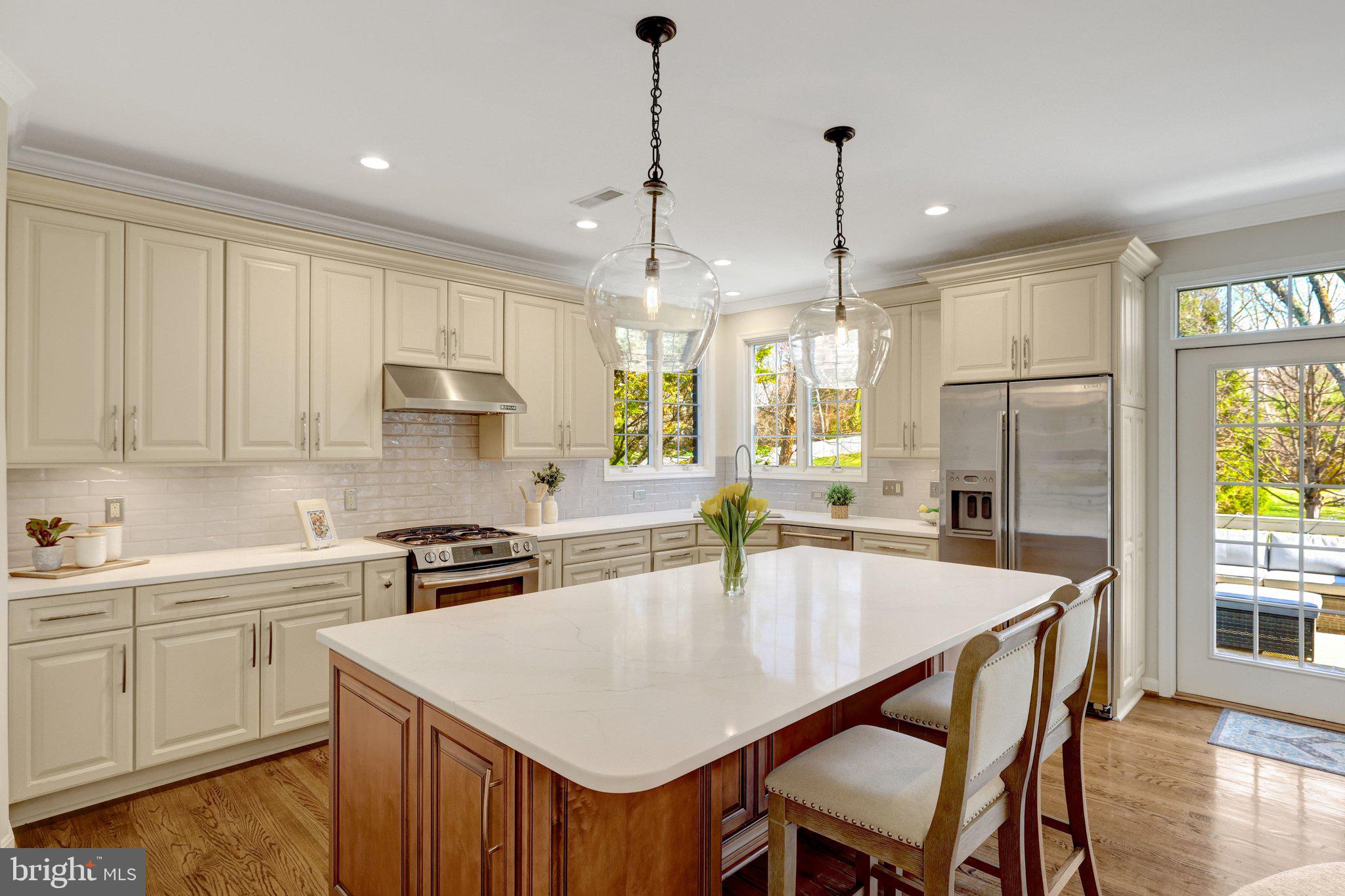 1827 Beulah Road Vienna, VA 22182 - Photo 27 of 91 a kitchen with a dining table chairs sink and cabinets