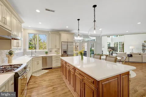 a bedroom with a large bed and a flat tv screen on dresser