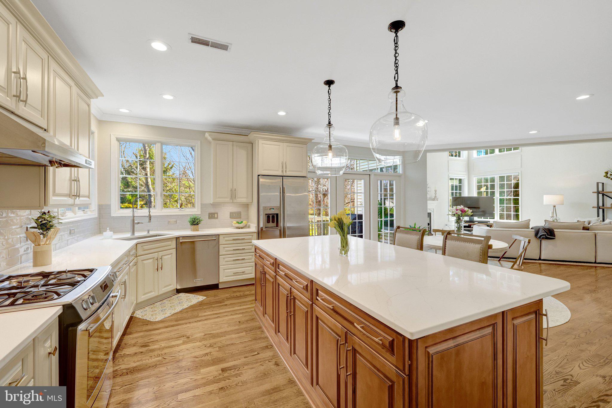 1827 Beulah Road Vienna, VA 22182 - Photo 29 of 91 a large kitchen with kitchen island a stove a sink a center island and windows
