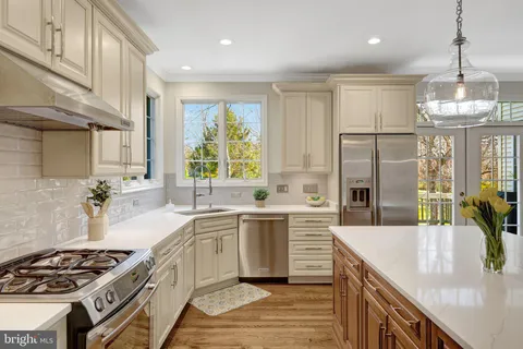 a spacious bathroom with a granite countertop tub sink shower and mirror