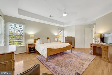 a spacious bedroom with a bed and a window