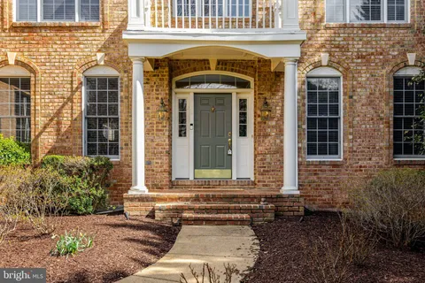 a view of a livingroom with wooden floor and a ceiling fan