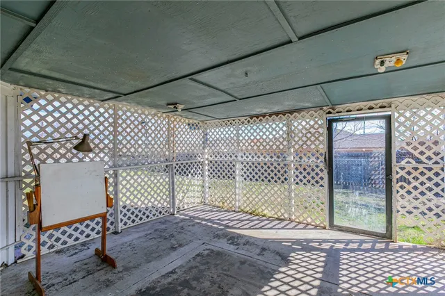 a view of a room with wooden floor and iron fence