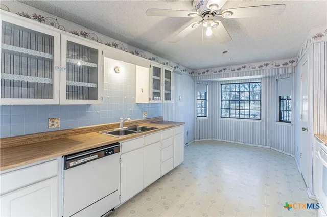 a kitchen with a cabinets and chandelier