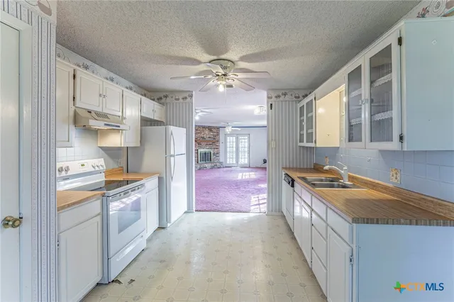 a kitchen with stainless steel appliances granite countertop a stove and a refrigerator
