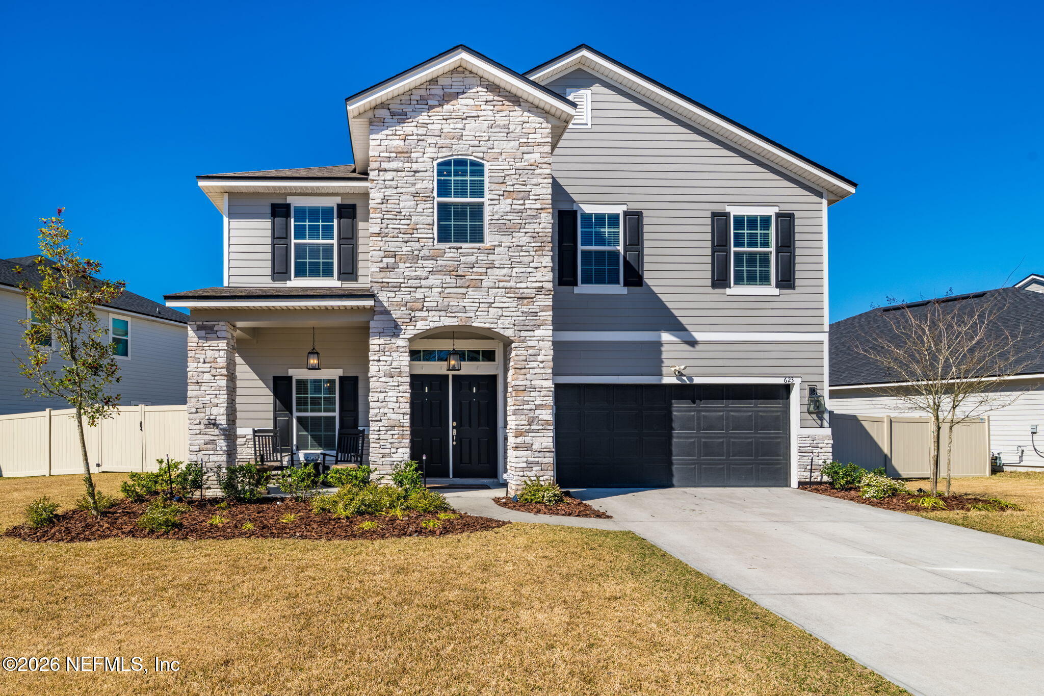 a front view of a house with a yard and garage