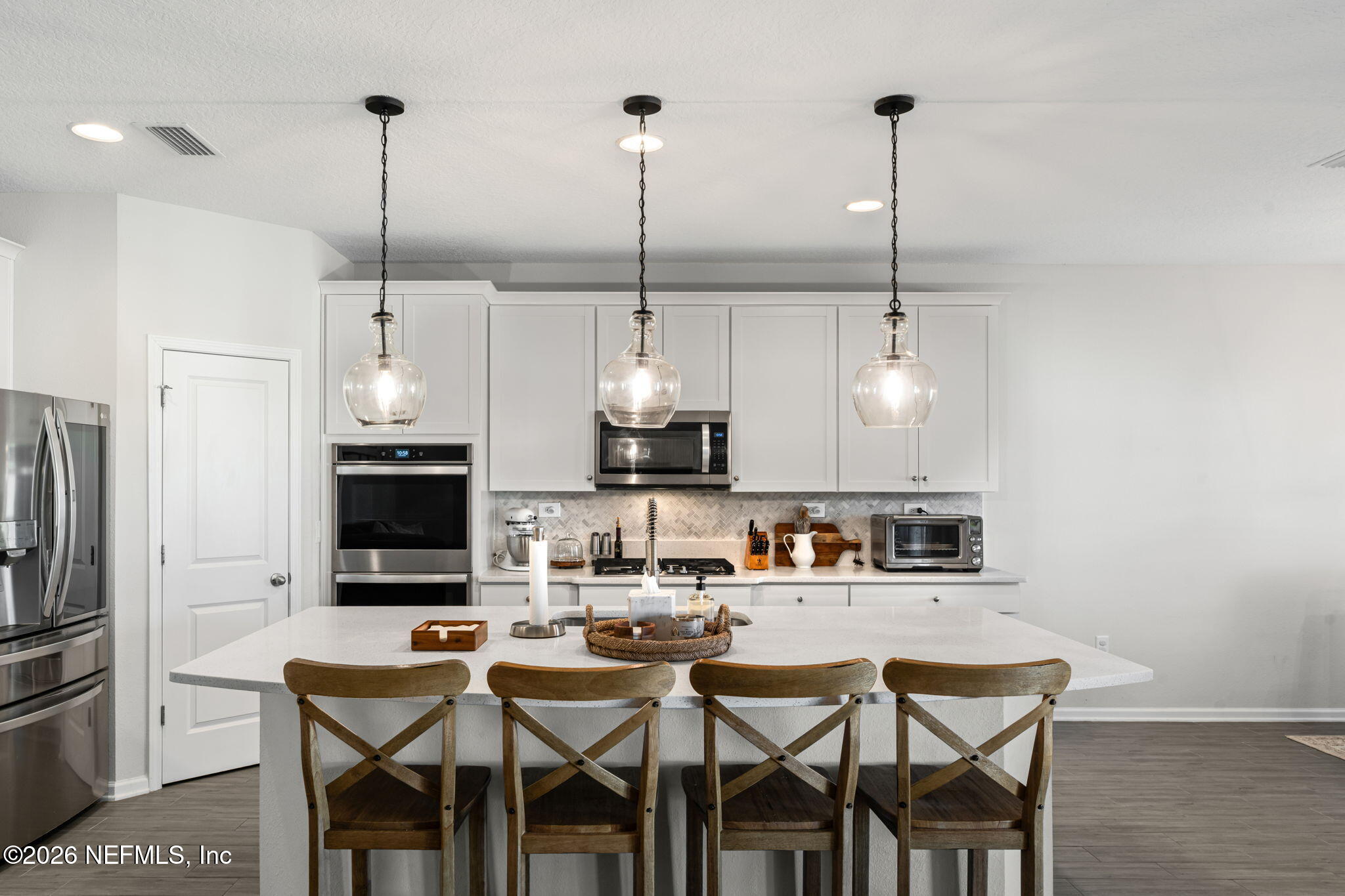 623 Ivory Palm Road Orange Park, FL 32073 - Photo 15 of 73 a kitchen with stainless steel appliances kitchen island granite countertop a sink a stove and a refrigerator