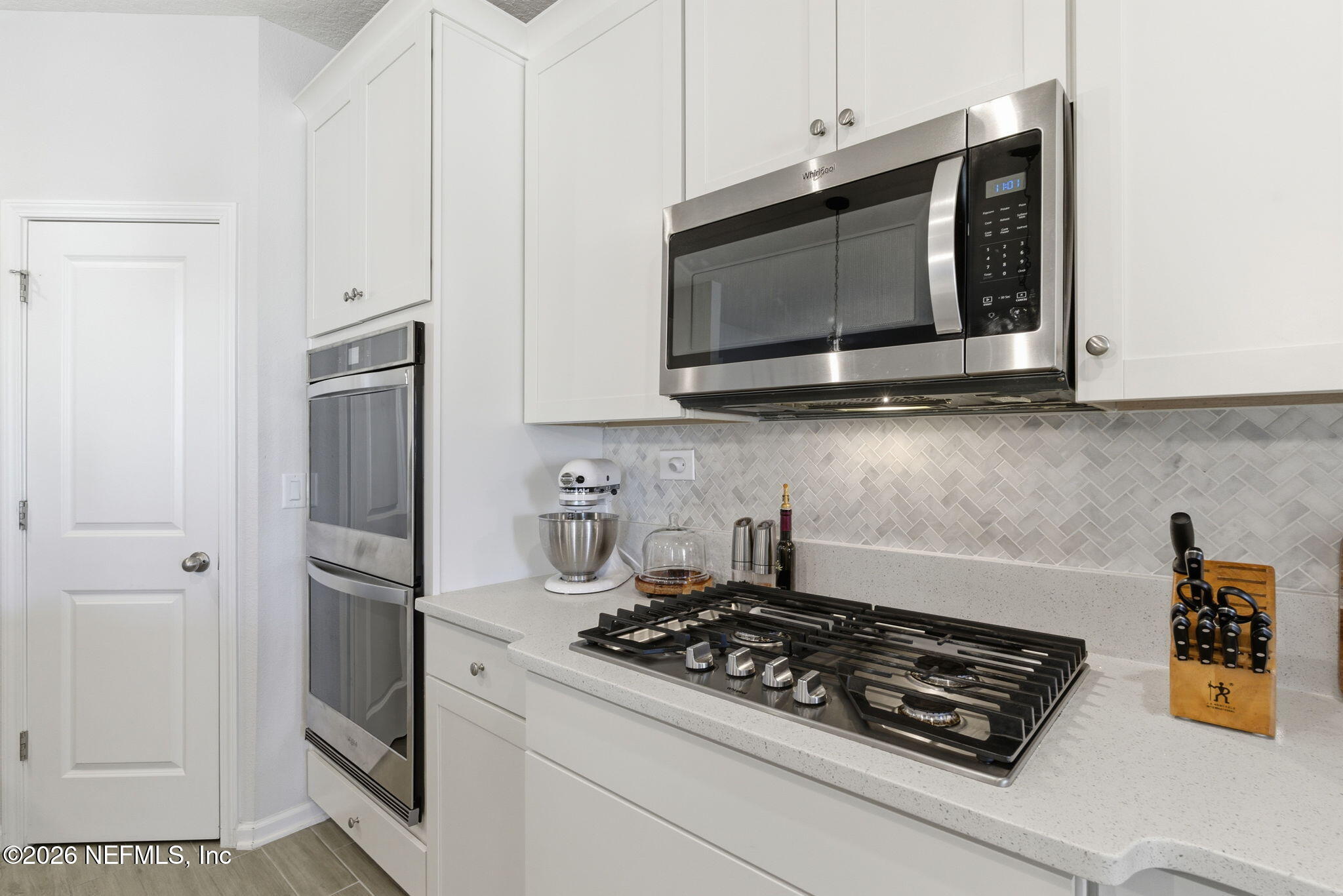 623 Ivory Palm Road Orange Park, FL 32073 - Photo 20 of 73 a kitchen with stainless steel appliances a stove a microwave and cabinets