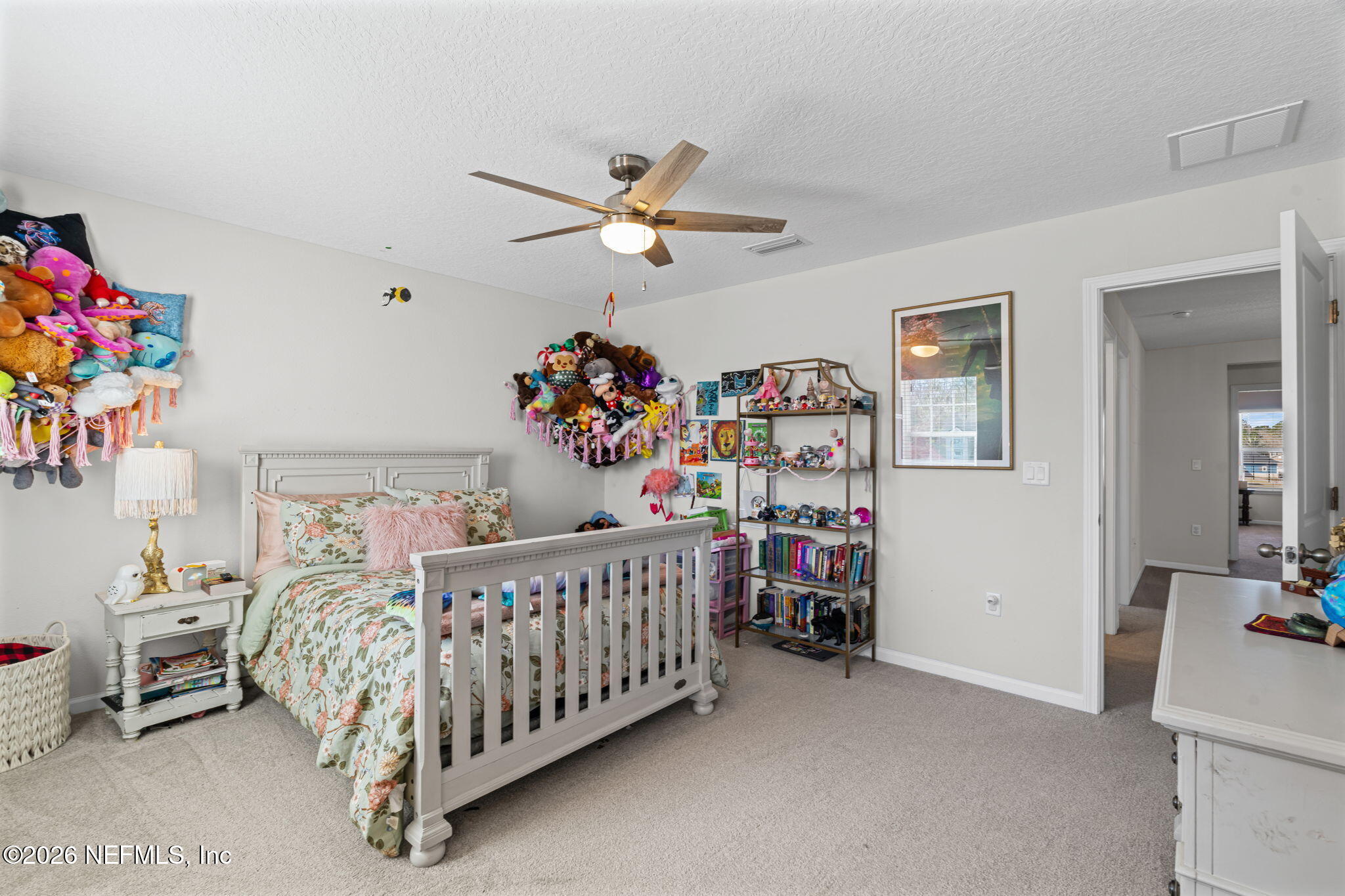 623 Ivory Palm Road Orange Park, FL 32073 - Photo 34 of 73 a bedroom with a bed and a chandelier