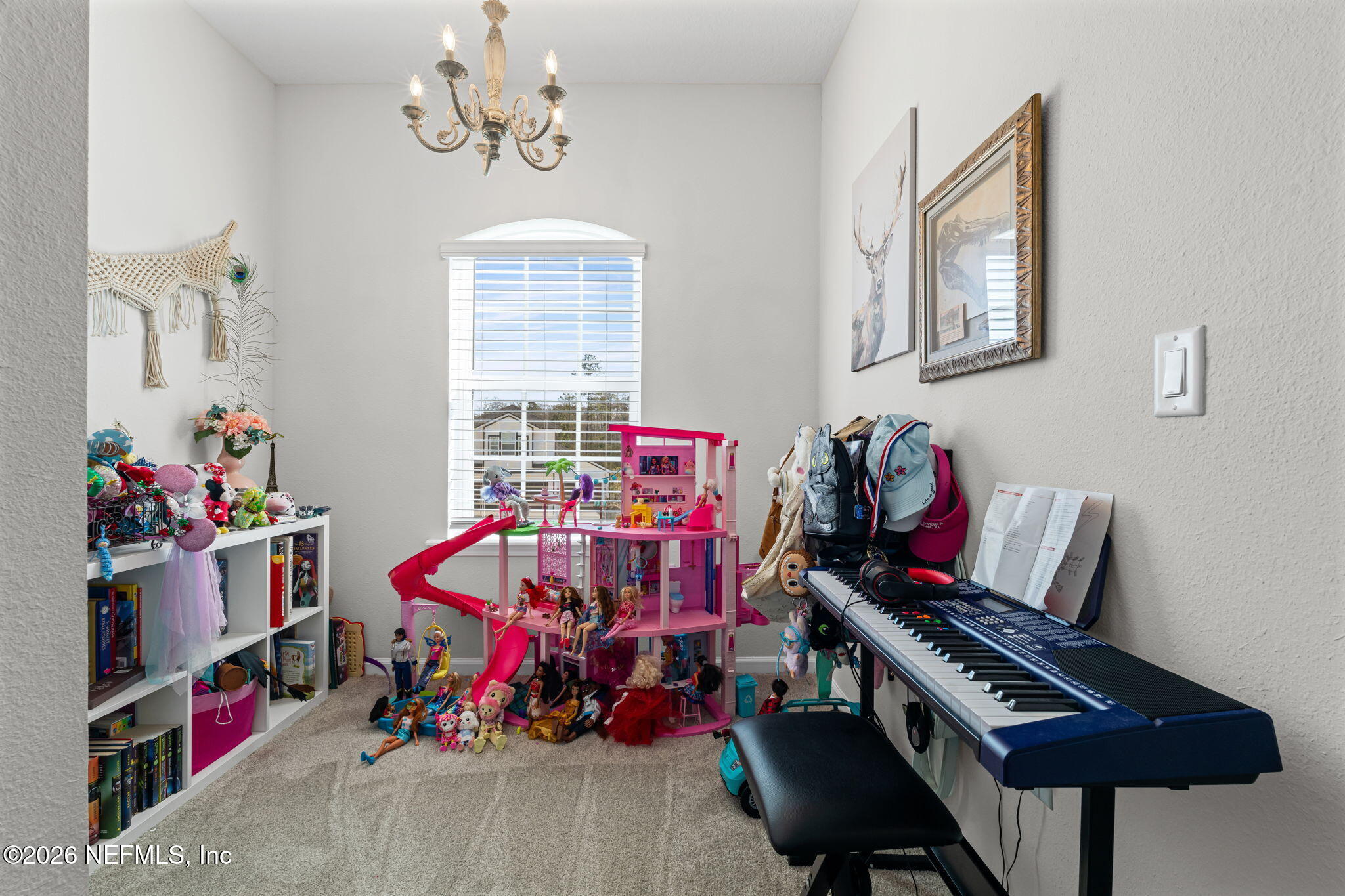 623 Ivory Palm Road Orange Park, FL 32073 - Photo 35 of 73 a bedroom with a bed and a chandelier