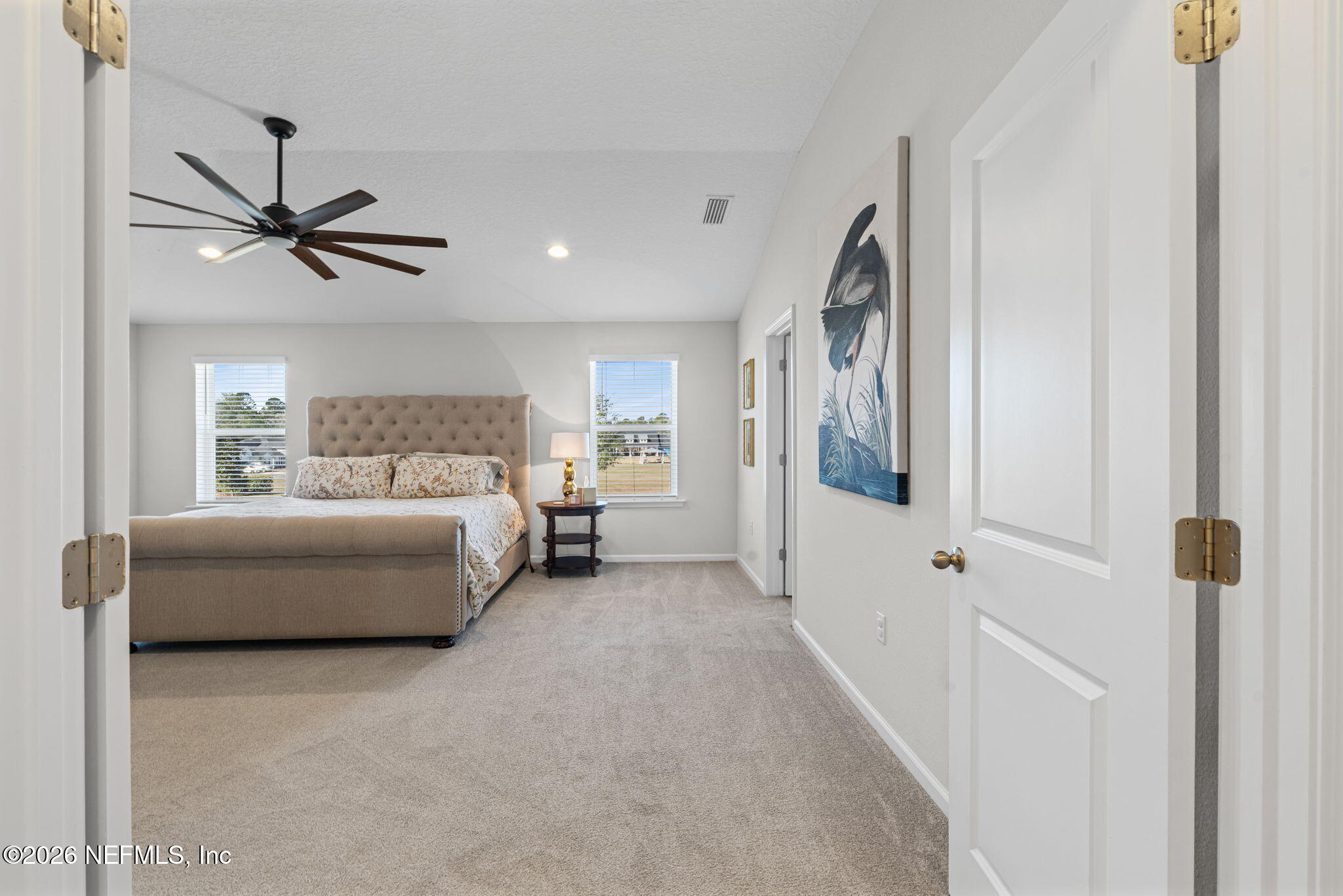 623 Ivory Palm Road Orange Park, FL 32073 - Photo 38 of 73 a spacious bedroom with a bed and a chandelier