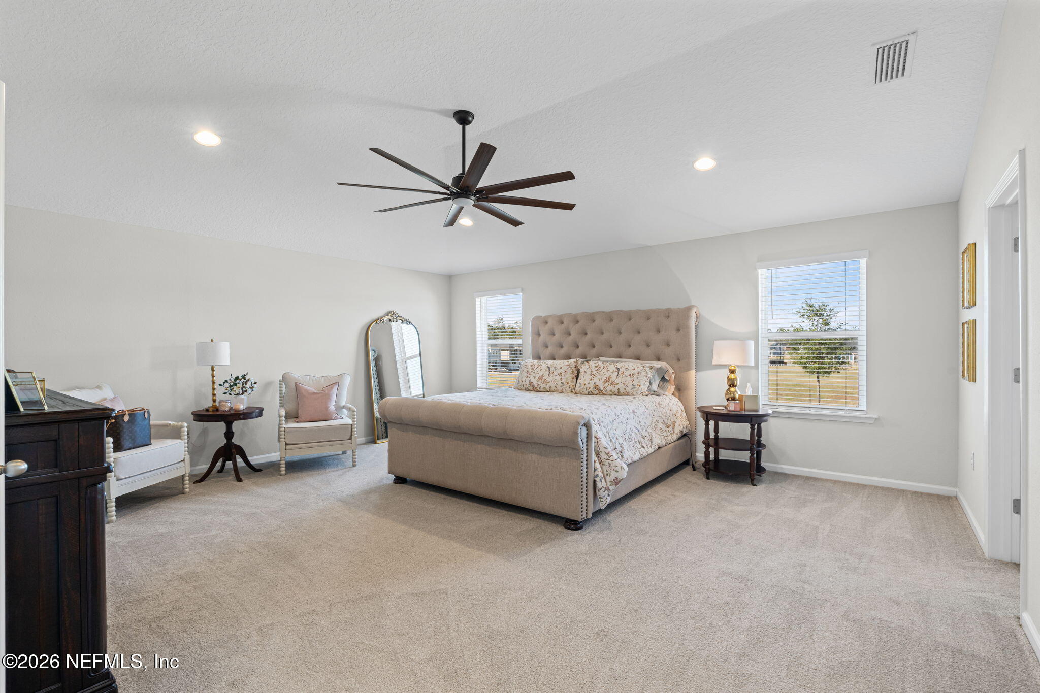 623 Ivory Palm Road Orange Park, FL 32073 - Photo 39 of 73 a bedroom with a bed large mirror and a window