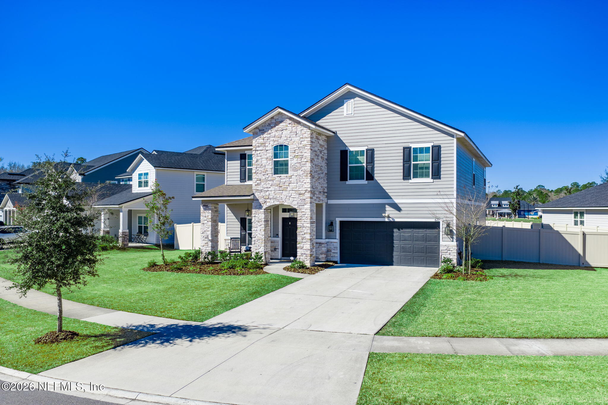 623 Ivory Palm Road Orange Park, FL 32073 - Photo 72 of 73 a front view of a house with a yard and garage