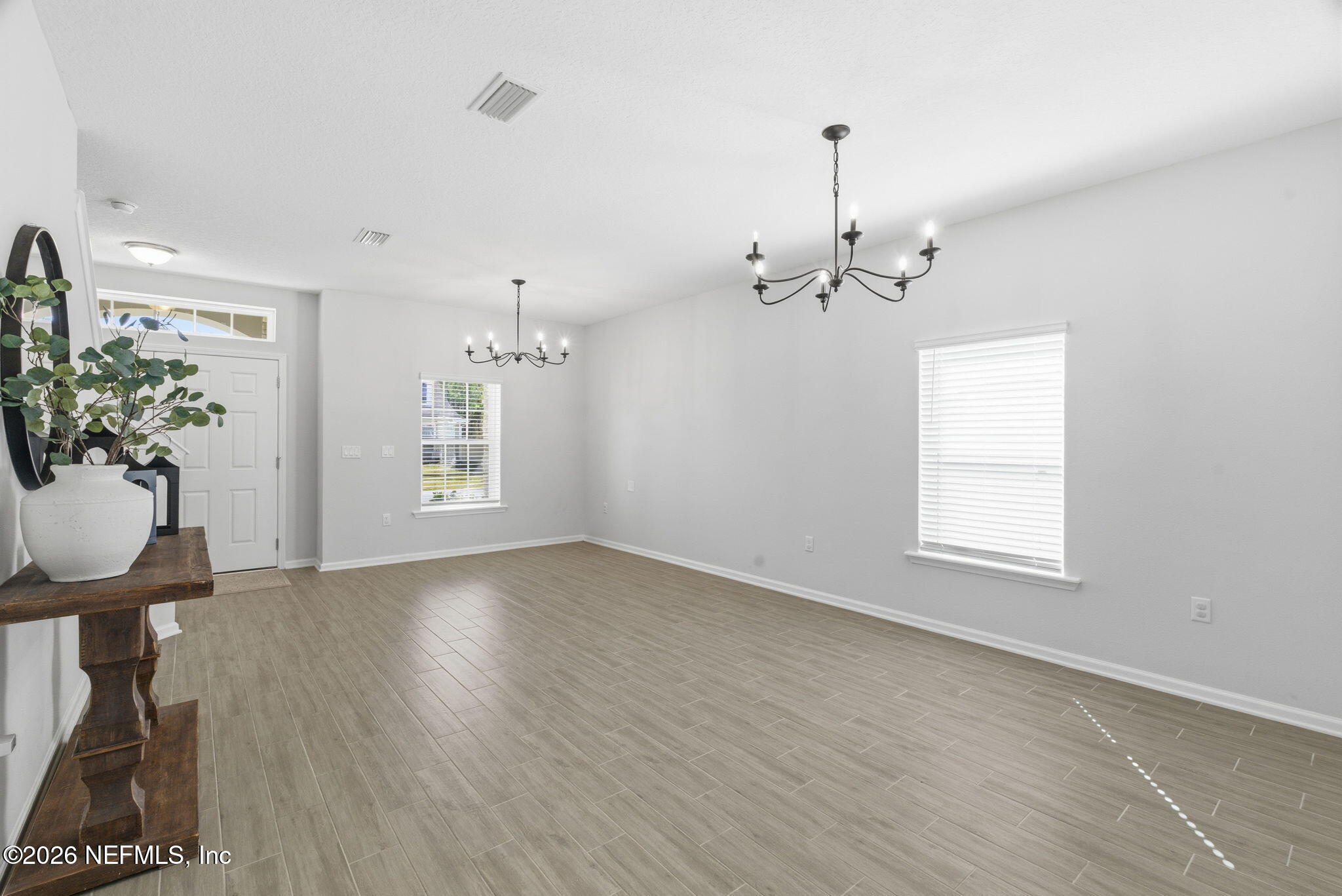 623 Ivory Palm Road Orange Park, FL 32073 - Photo 9 of 73 a view of a room with wooden floor potted plants and a chandelier