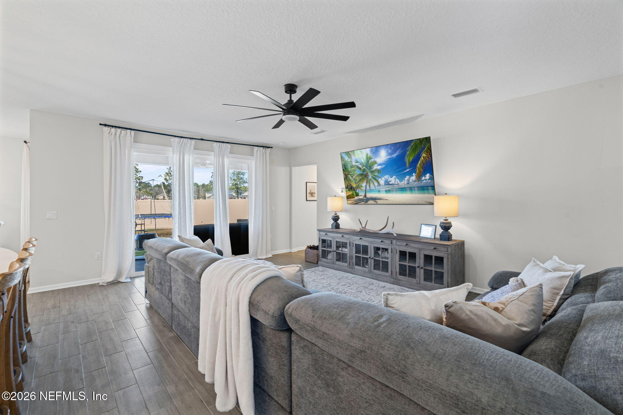 623 Ivory Palm Road Orange Park, FL 32073 - Photo 10 of 73 a living room with furniture a large window and a flat screen tv