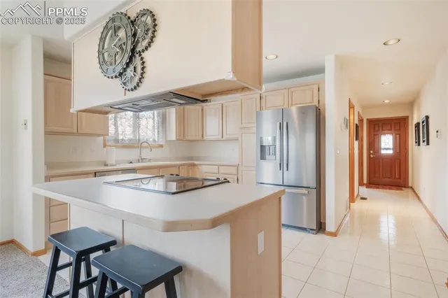 a kitchen with stainless steel appliances a stove a refrigerator and a cabinets