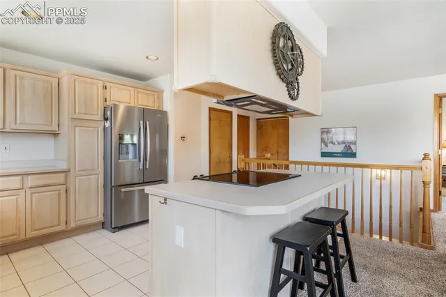 a kitchen with stainless steel appliances a stove a refrigerator and a cabinets