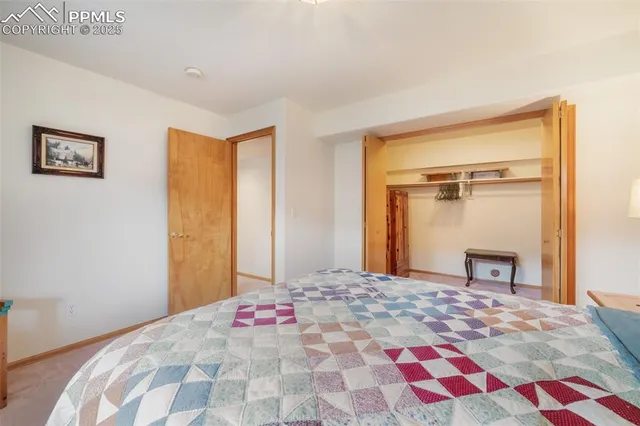 a bedroom with a bed and a lamp