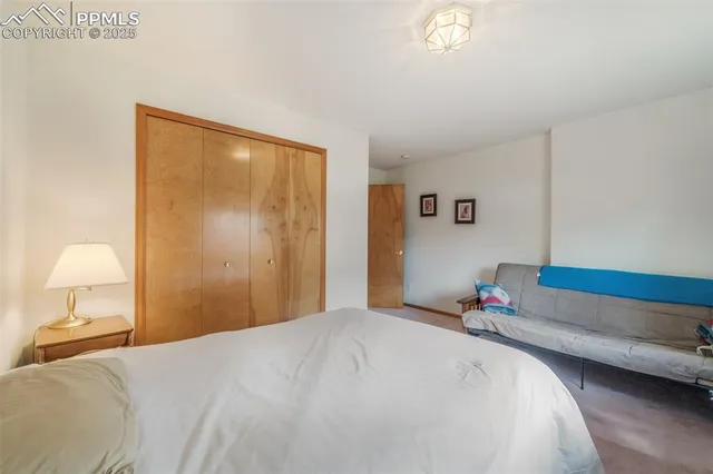 a spacious bedroom with a bed and a window