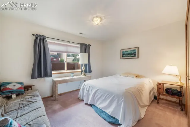 a bedroom with a bed and a painting on the wall