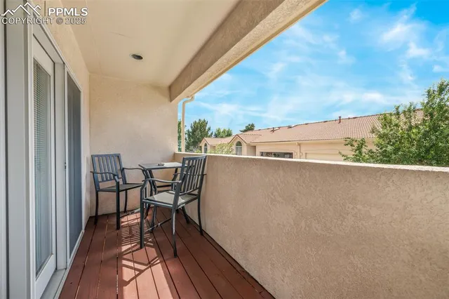 a view of a terrace with chairs and a table