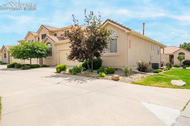 a front view of a house with a yard and a garage