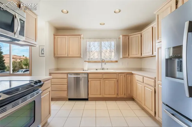 a kitchen with stainless steel appliances granite countertop a sink and a stove