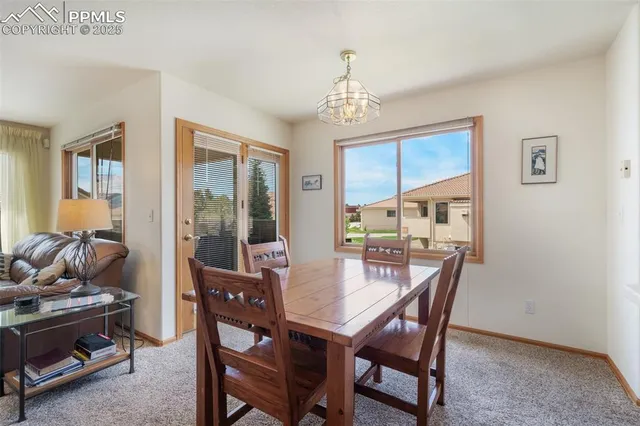 a view of a dining room with furniture window and outside view