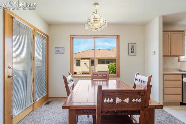 a dining room with furniture a chandelier and wooden floor