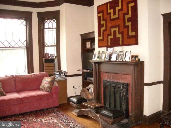5504 Wexford Road Baltimore, MD 21209 - Photo 15 of 18 a living room with furniture a window and a fireplace