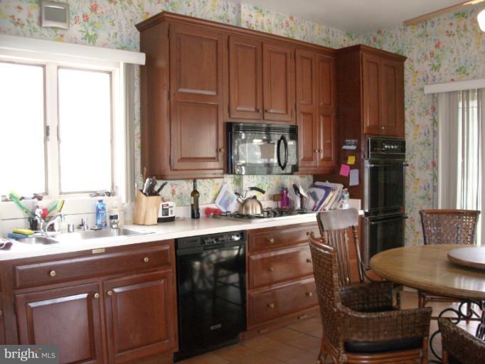 5504 Wexford Road Baltimore, MD 21209 - Photo 16 of 18 a kitchen with a sink cabinets and window