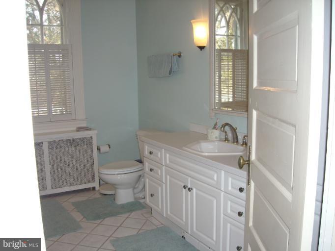 5504 Wexford Road Baltimore, MD 21209 - Photo 6 of 18 a bathroom with a sink toilet and window