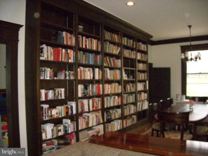 5504 Wexford Road Baltimore, MD 21209 - Photo 10 of 18 a view of a workspace with furniture and a bookshelf