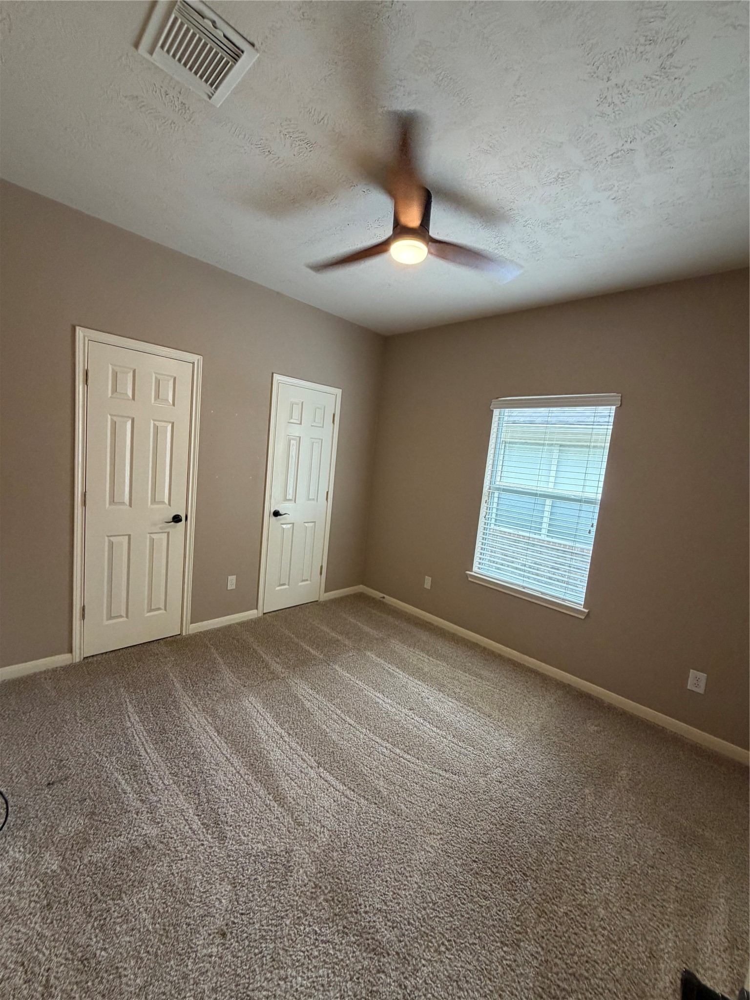 903 Cascade Ridge Katy, TX 77494 - Photo 15 of 24 an empty room with windows and fan