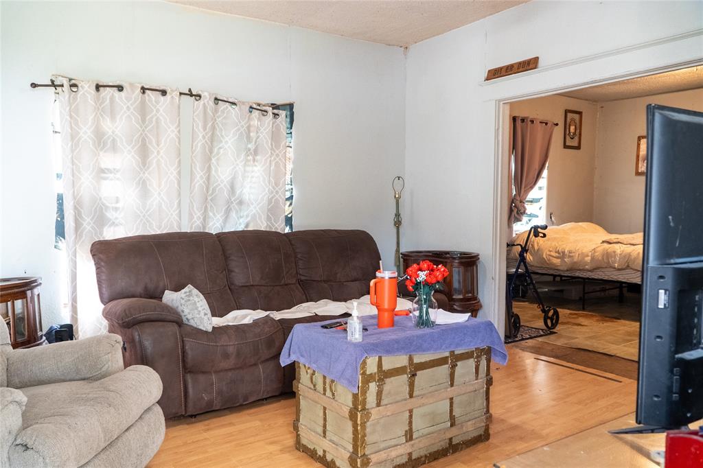 1810 Live Oak Street Commerce, TX 75428 - Photo 6 of 6 Living area with light wood-style floors