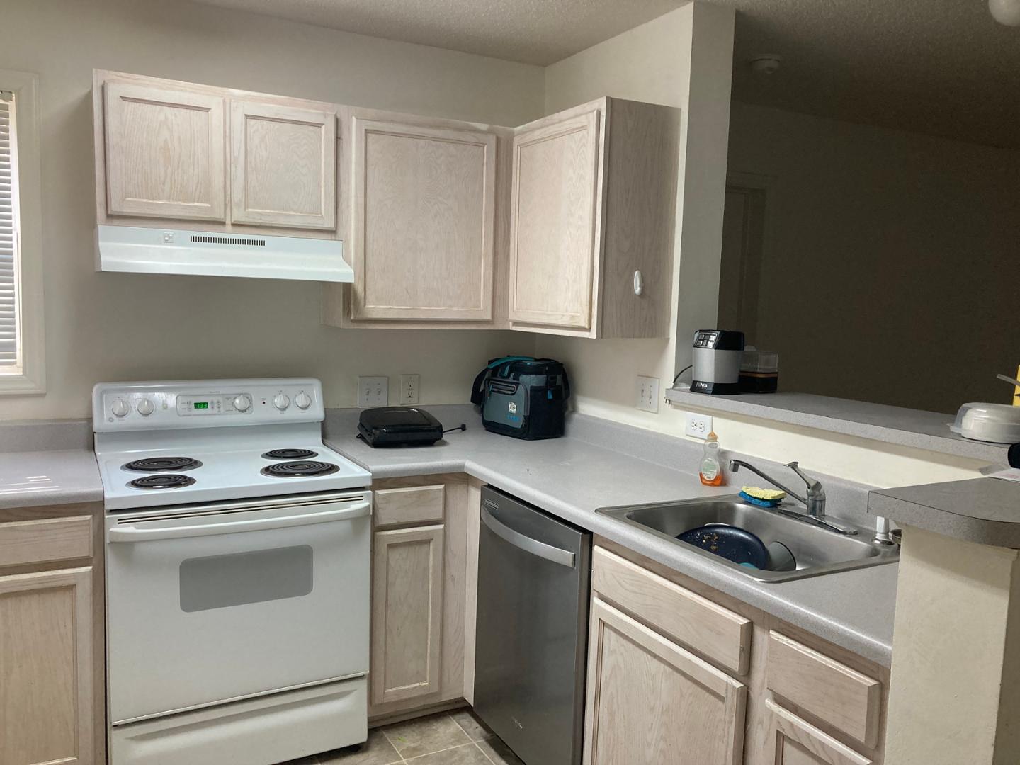 3770 Pardue Woods Place, Unit 102A Raleigh, NC 27603 - Photo 3 of 13 a kitchen with white cabinets and white appliances