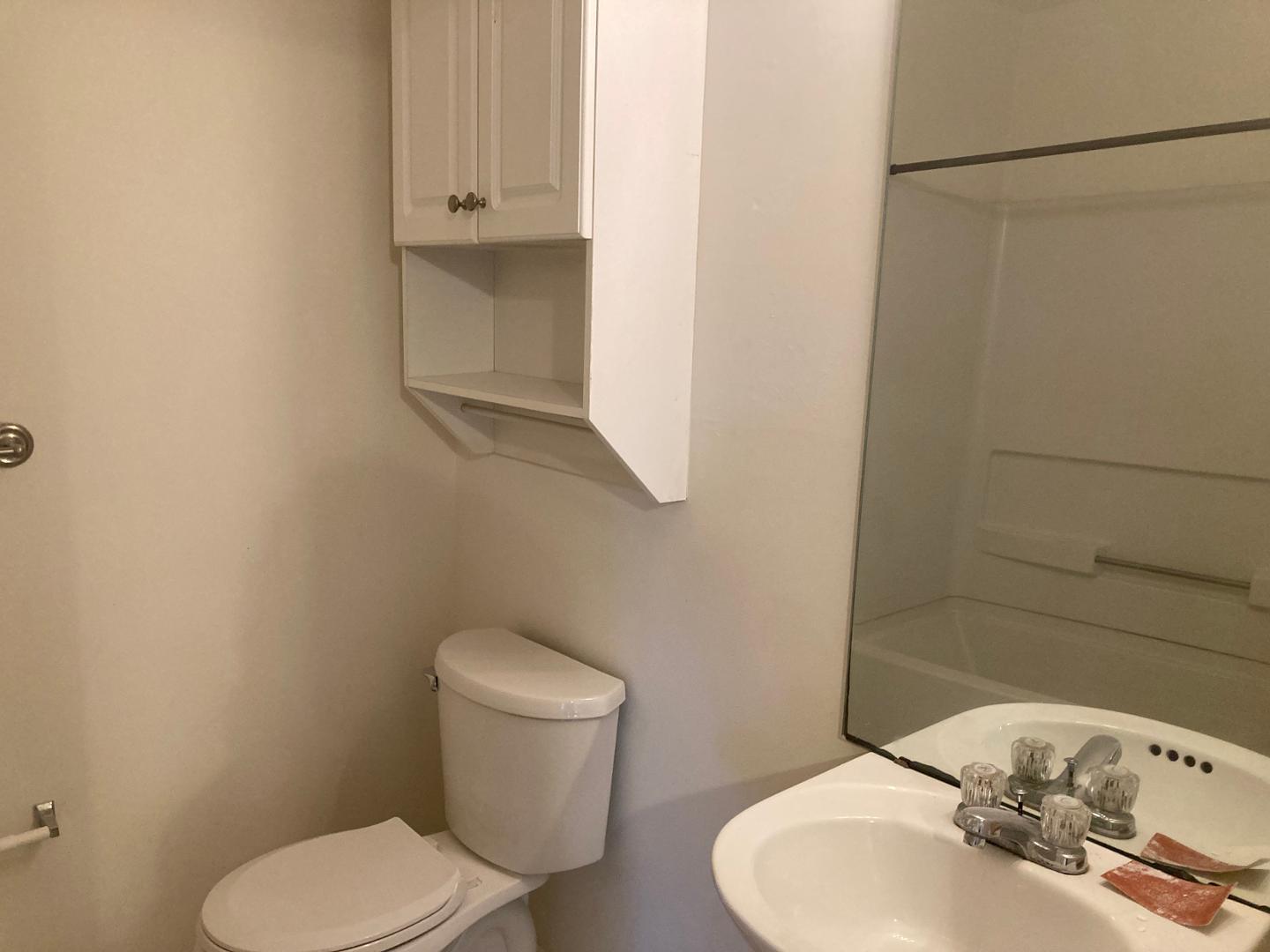 3770 Pardue Woods Place, Unit 102A Raleigh, NC 27603 - Photo 9 of 13 a white toilet sitting next to a bathroom sink