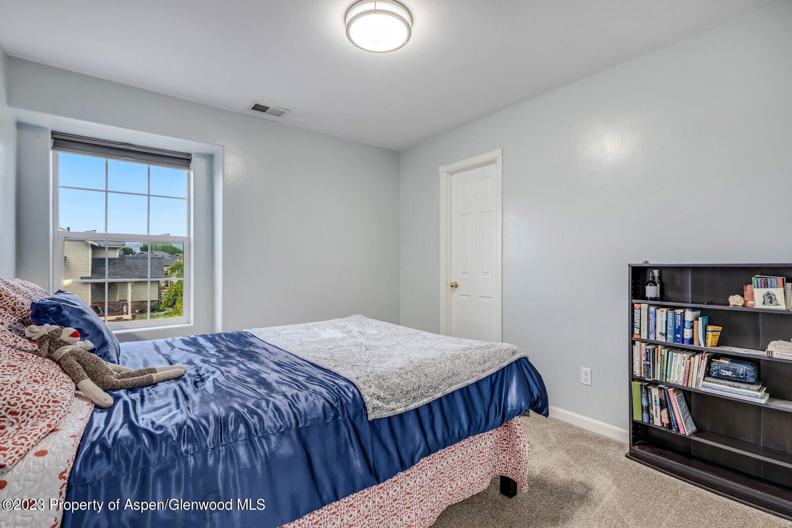 1391 East 17th Street Rifle, CO 81650 - Photo 21 of 36 a bedroom with a bed and a book shelf