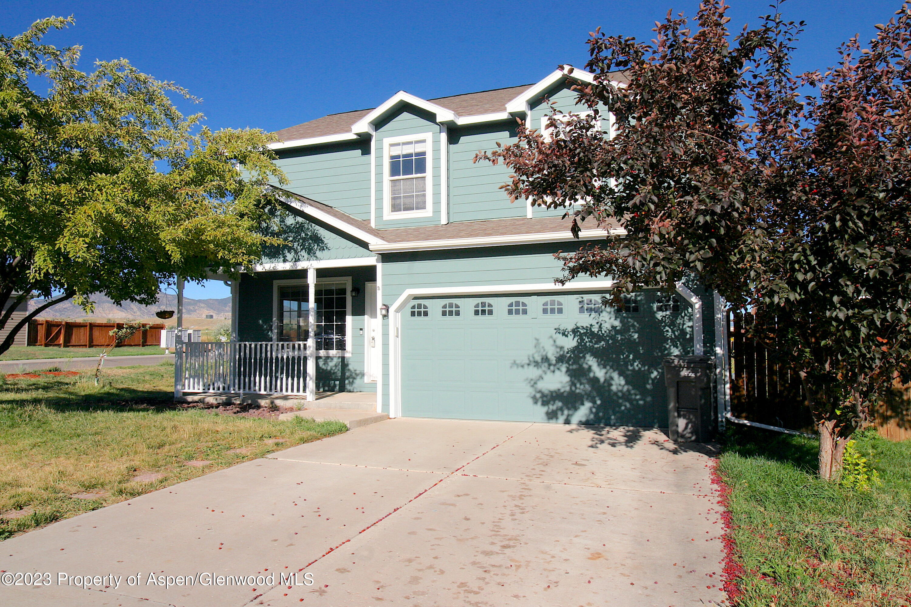 1391 East 17th Street Rifle, CO 81650 - Photo 6 of 36 a front view of a house with a garden and trees