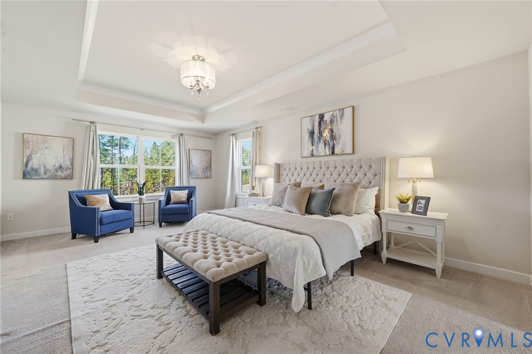 4730 Hepler Ridge Way Glen Allen, VA 23059 - Photo 22 of 39 a spacious bedroom with a bed and a chandelier
