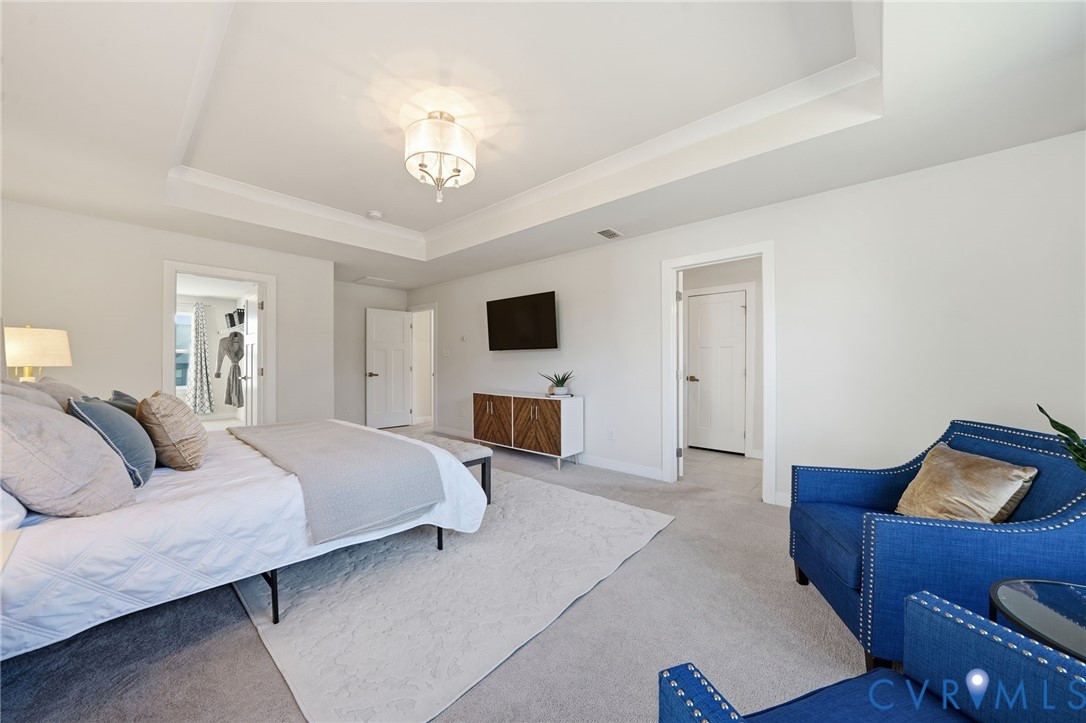 4730 Hepler Ridge Way Glen Allen, VA 23059 - Photo 23 of 39 a spacious bedroom with a bed and flat screen tv